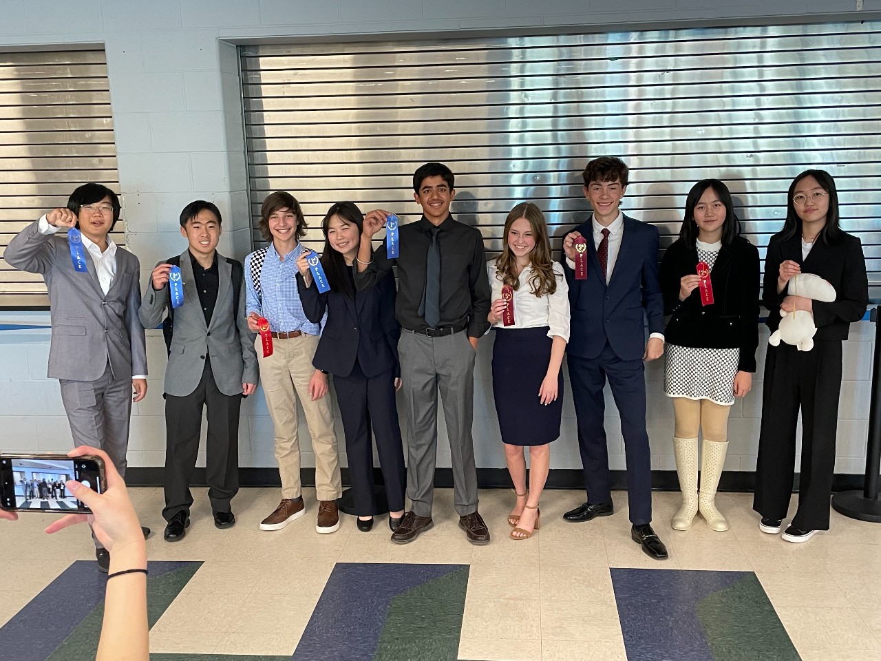 Students pose with ribbons after Speech and Debate competition